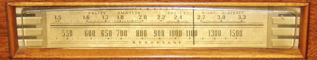 The radio dial on an old 1930s wood-panel radio