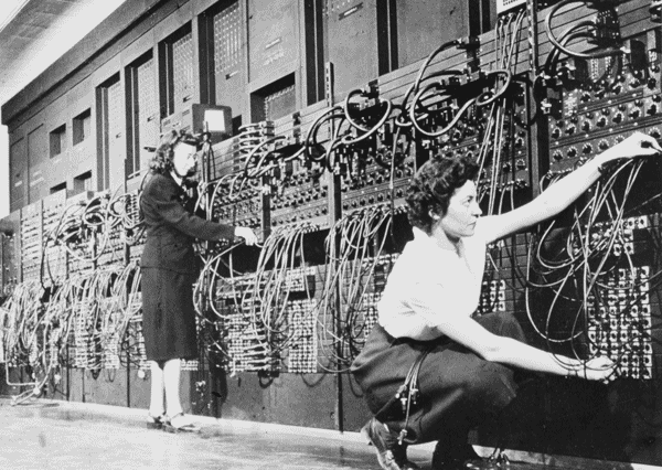 Photo of two women operating the control panel of the ENIAC