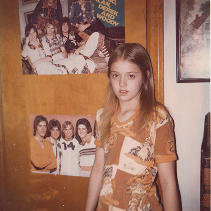 Girl with posters behind her in another time
